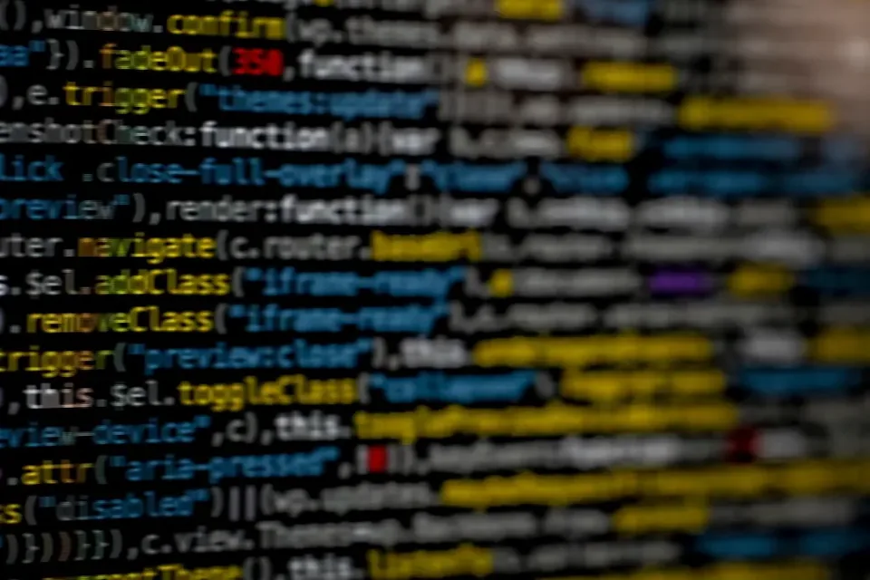 A screen of colourful JavaScript code shot at an angle, with only a few lines in focus